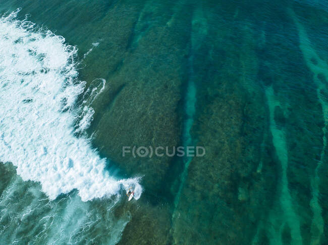Indonesia, Sumbawa, Aerial view of surfer on sea — Stock Photo