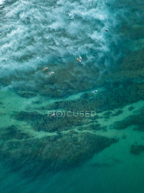 Indonesia, Sumbawa, Aerial view of group of surfers — Stock Photo