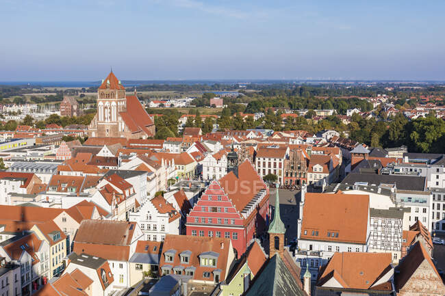 Germany, Mecklenburg-Western Pomerania, Greifswald, High angle view of buildings surrounding old town market square — Stock Photo