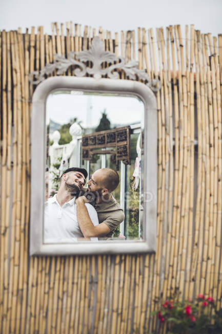 Mirror image of gay couple in love — Stock Photo