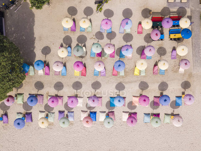 Indonesia, Bali, Nusa Dua, Aerial view of colorful umbrellas on resort beach — Stock Photo