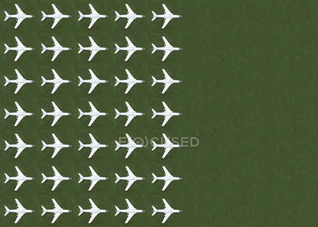 Aerial view of rows of airplanes standing on green grass — Stock Photo