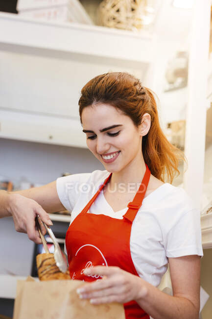 Junge Frau arbeitet in einer Bäckerei — Stockfoto