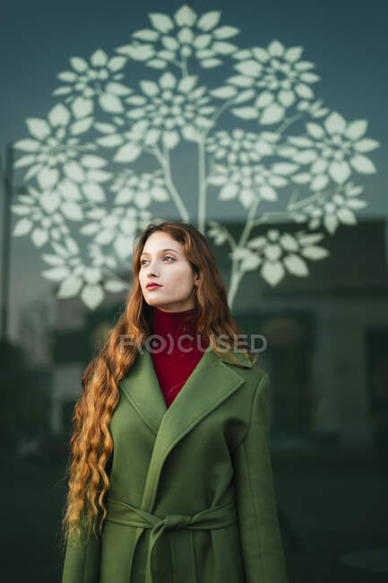 Portrait of redheaded young woman looking at distance — Stock Photo