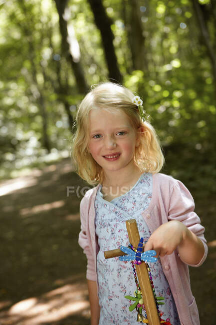 Portrait of a girl with hand cart in forest — Stock Photo