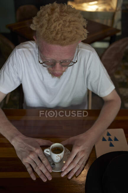 Vista dall'alto di un albino che prende una tazza di caffè — Foto stock