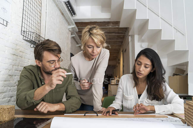 Colleagues discussing in architectural office — Stock Photo