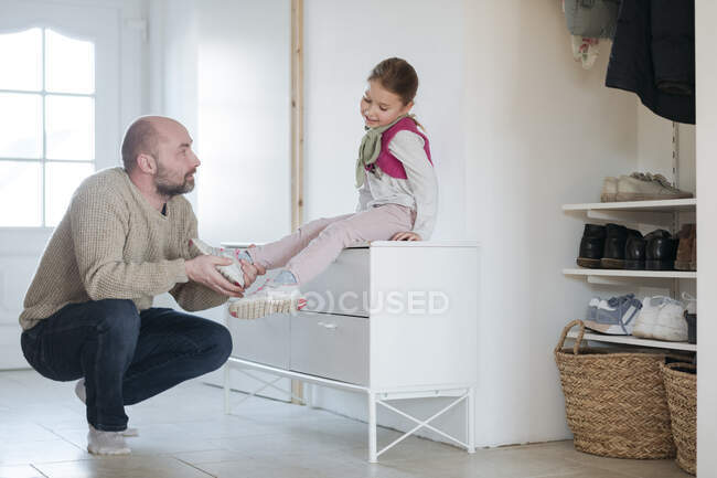 Father and daughter ironing together at home — Stock Photo