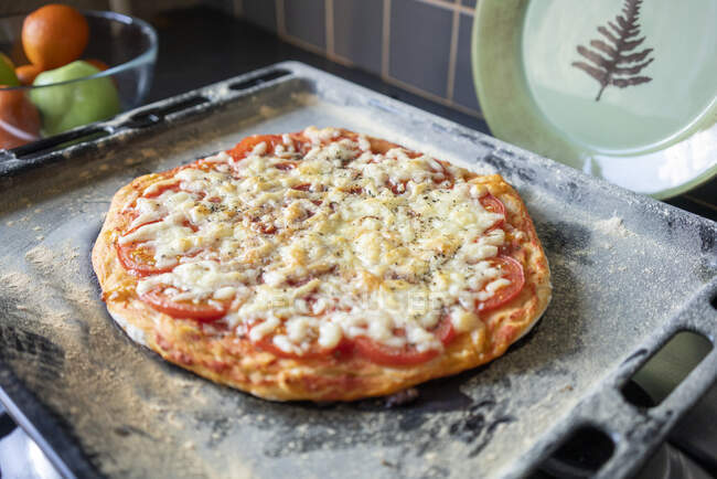 Homemade pizza on baking tray — Stock Photo