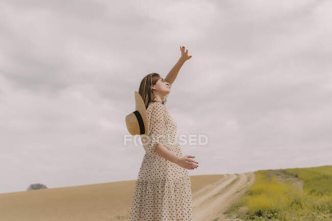 Woman in vintage dress alone at a remote field in the countryside — Stock Photo