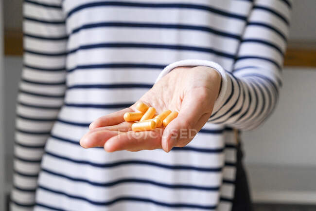 Close-up of woman holding pills — Stock Photo