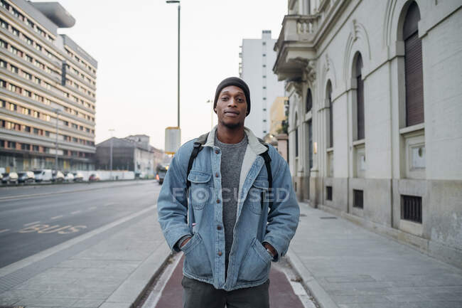 Portrait of young man standing on bicycle lane in the city, Milan, Italy — Stock Photo