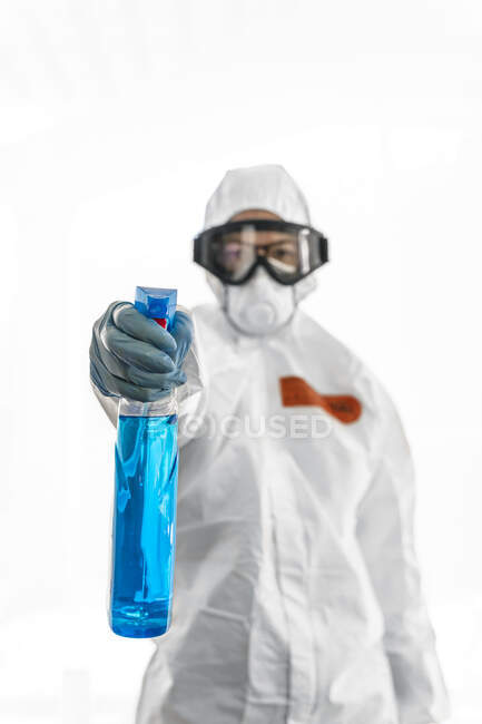 Woman wearing protective clothes, sanitizing her home — Stock Photo
