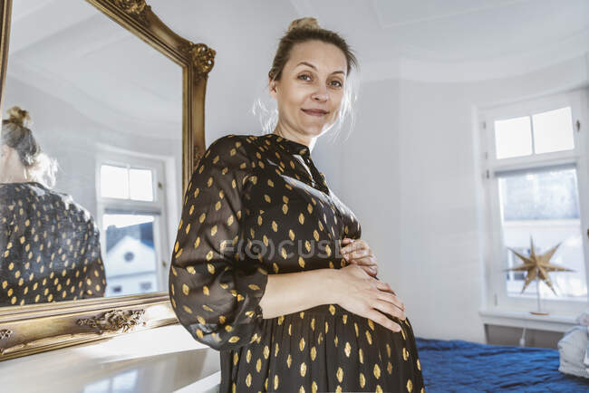Portrait of pregnant woman at home — Stock Photo