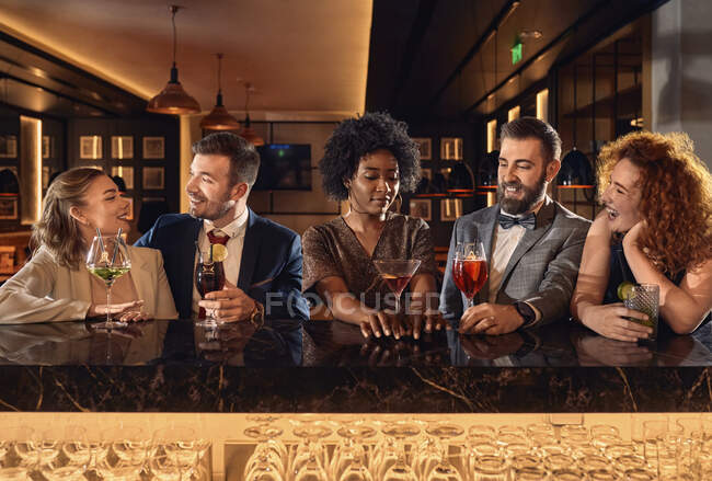 Happy friends socializing in a bar — Stock Photo