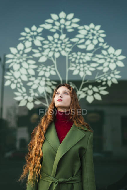 Portrait of redheaded young woman with red lips looking up — Stock Photo