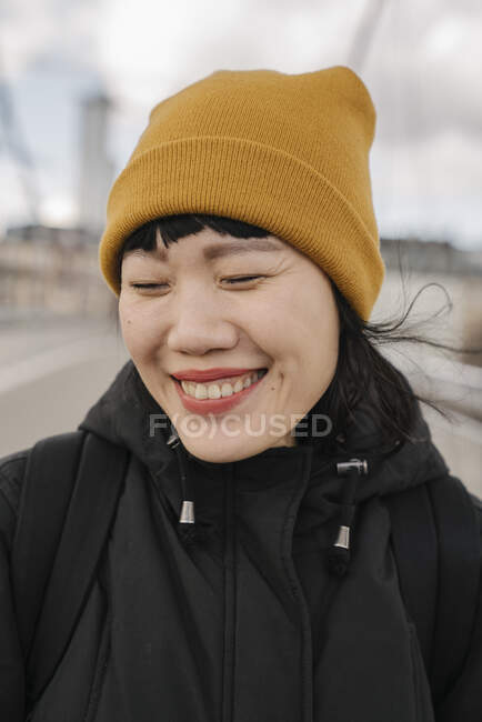 Portrait of happy woman with closed eyes on a bridge — Stock Photo
