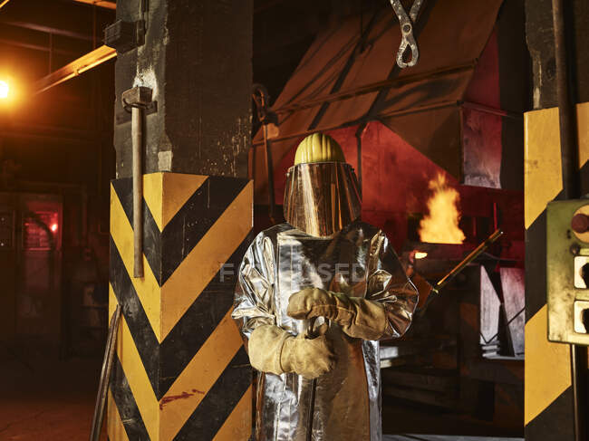 Worker wearing protective workwear standing in foundry — Stock Photo