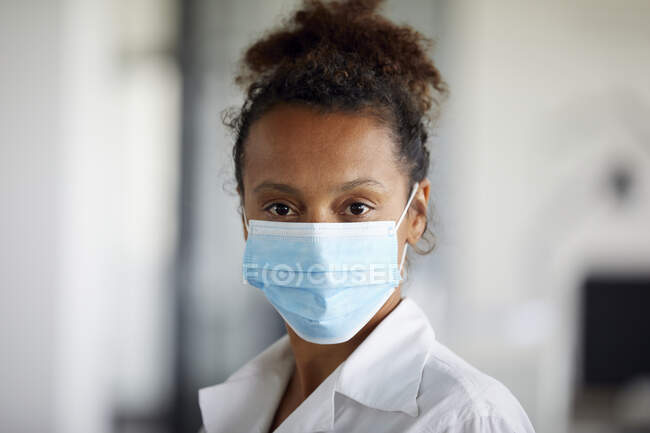 Портрет деловой женщины в светло-голубой защитной маске — стоковое фото