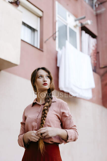 Portrait of young woman with braid wearing vintage clothes — Stock Photo