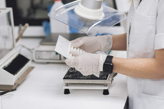 Mature female doctor holding medical equipment at laboratory — Stock Photo