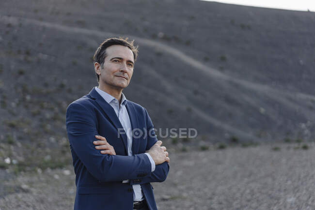 Portrait of a confident mature businessman on a disused mine tip — Stock Photo