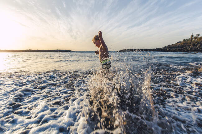 Boy playing in the water at the seafront, Adeje, Tenerife, Canarian Islands, Spain — Stock Photo