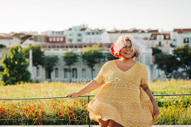 Cheerful body positive woman standing at park in city — Stock Photo