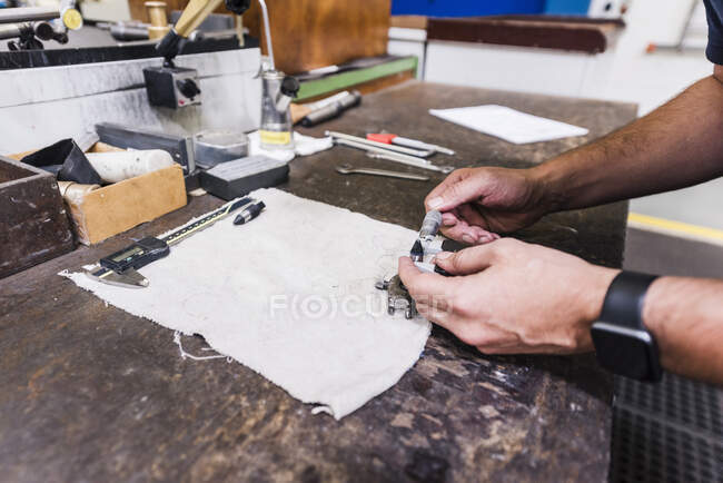 Close-up of man working at workbench in a factory — Stock Photo