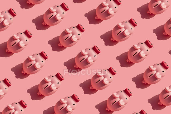 Padrão sem costura de linhas de bancos porquinhos contra o fundo rosa pastel — Fotografia de Stock