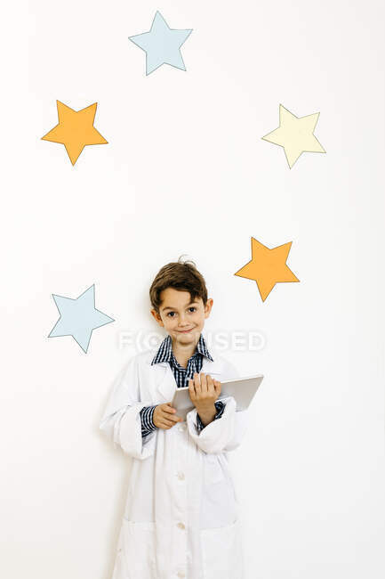 Boy with clipboard playing researcher — Stock Photo