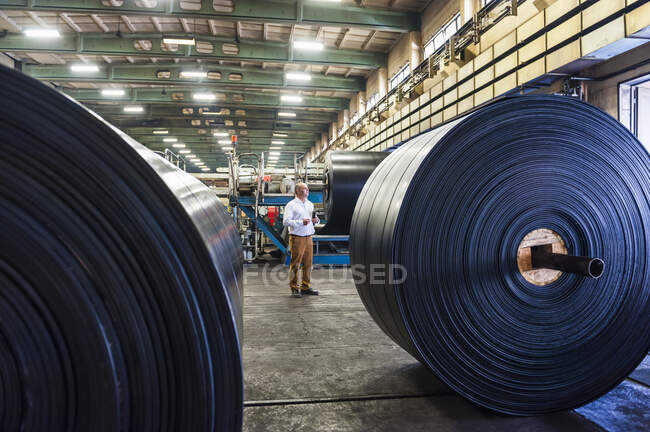 Senior businessman in a rubber processing factory — Stock Photo