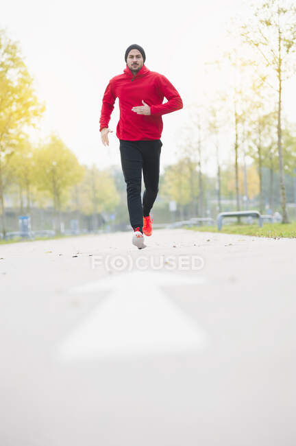 Young man running on a lane — Stock Photo