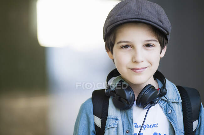 Confident boy wearing headphones around neck outdoors — Stock Photo