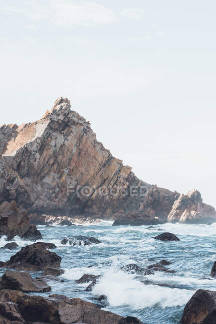 Scenic view of sea and mountain against sky, Ursa beach, Portugal — Stock Photo