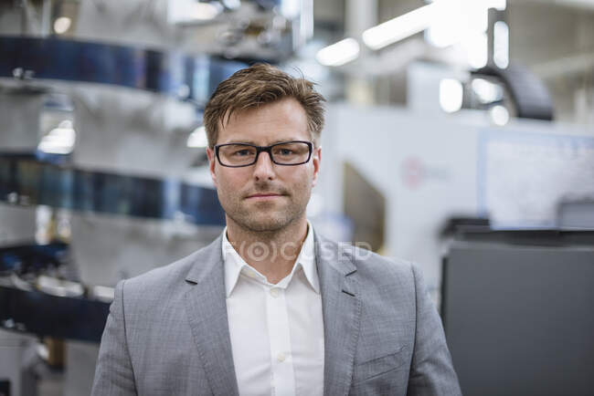Portrait of a confident businessman in factory — Stock Photo