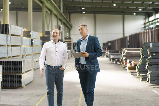 Двое бизнесменов встречаются и идут на фабрику — стоковое фото