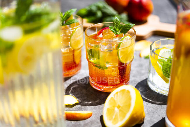 Cocktail with peach, mint and lime and ice cubes — Stock Photo
