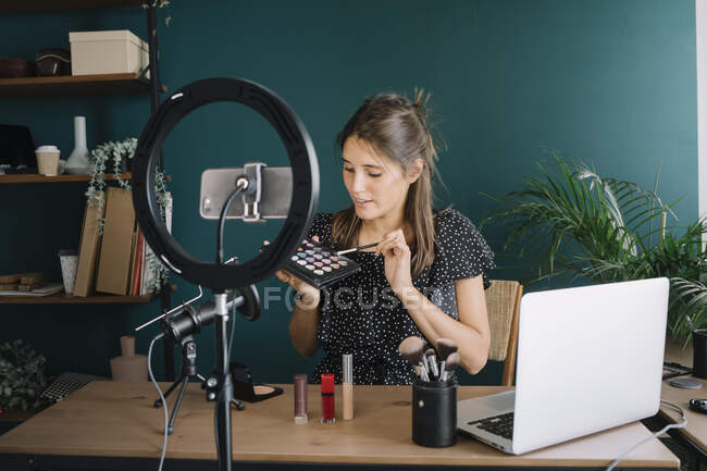 Young woman making a makeup video tutorial — Stock Photo