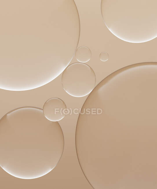 Renderizado tridimensional de esferas de vidrio transparente sobre fondo marrón claro - foto de stock