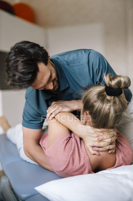Physiotherapist giving treatment to female patient — Stock Photo