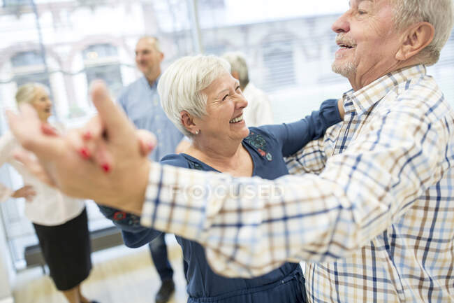 Group of active senior attending dance course in retirement home ...