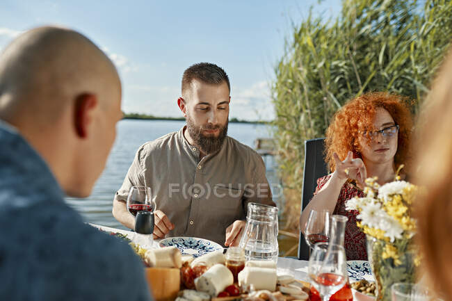 Amis dînant dans un lac — Photo de stock