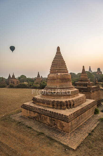 Myanmar, Mandalay Region, Bagan, Ancient stupas at dawn — banner, background  - Stock Photo | #476781260