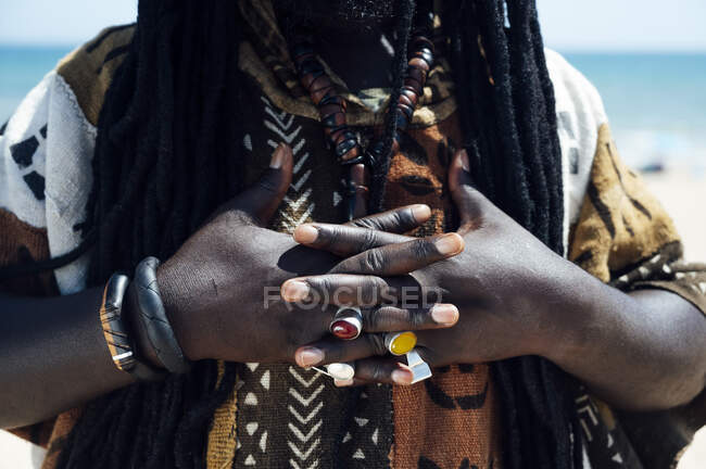 Hands with jeweled rings of man with dreadlocks — Stock Photo