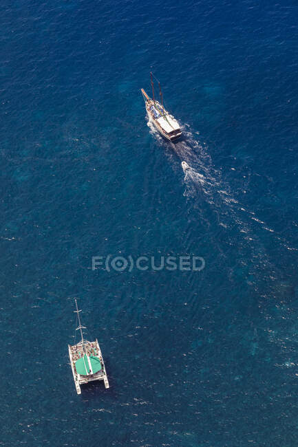 Portugal, Aerial view of tourboat psailing past catamaran on blue waters of Atlantic Ocean — Stock Photo