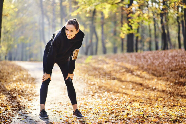 Young woman during break in autumn forest — Stock Photo
