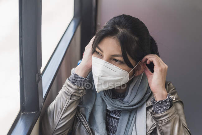 Жінка носить маску в автобусі під час спалаху коронавірусу. — стокове фото