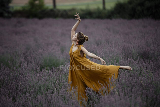 Woman dancing in lavender field — Stock Photo