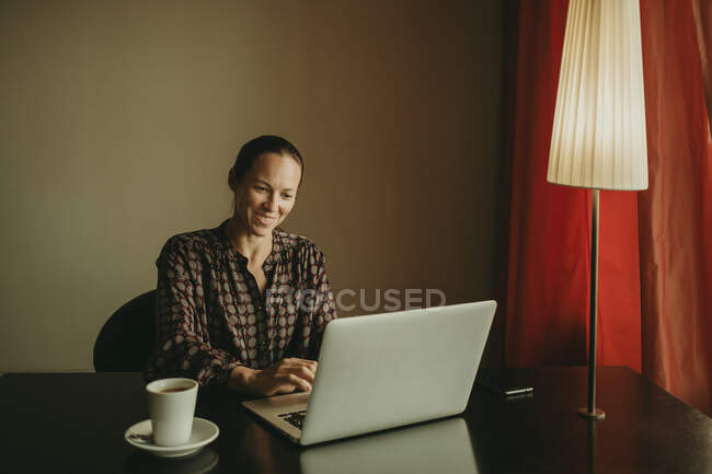 Empresária sorrindo enquanto trabalhava no escritório — Fotografia de Stock